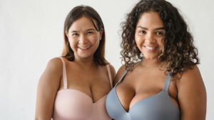 Two women in supportive bras shown for a breast reduction surgery page
